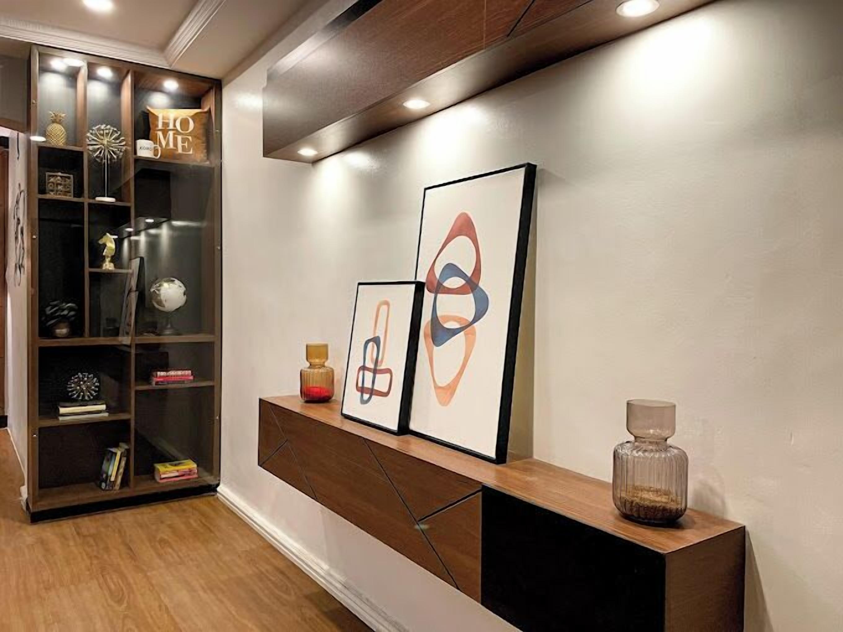 A modern interior with a wooden console table, a decorative globe, and abstract art pieces.
