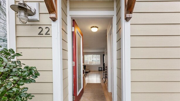 A narrow hallway with a wooden door, a number '22' sign, and a small window at the end. - Escape to the scenic heights of Hood River (Hood River)