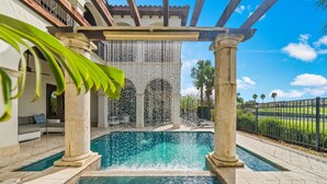 A pool area with a pergola, columns, and a water feature. - 5BR Luxury Villa • Games & Golf • Near Disney (Reunion)