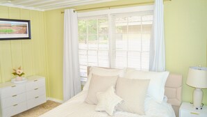 A bedroom with a bed, a nightstand, a dresser, and a window with curtains. - Bright & Cozy, Walk To Downtown, 3.5 Miles to Stadium.Grill, LightUp Vanity&Crib (Austin)