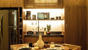 A modern kitchen with a built-in refrigerator, microwave, and coffee maker. - Jungle & Relax: Private Pool- Garden Wifi  (Tulum)