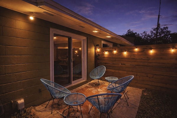 Patio Retreat: Unwind under twinkling lights amidst vibrant seating!