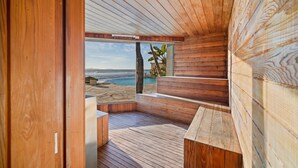 A wooden interior with a view of the ocean. - Luxury Ocean Front Modern Condo in Rosarito BC (Rosarito)