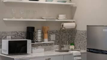 Fridge, microwave, coffee/tea maker, cookware/dishes/utensils