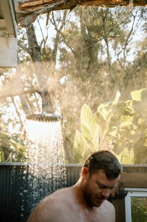 A person in a covered outdoor area with a water feature.