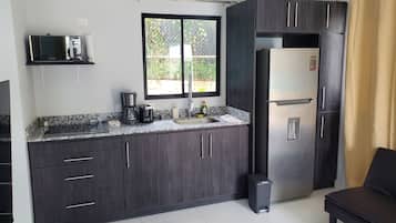 Full-size fridge, microwave, stovetop, cookware/dishes/utensils