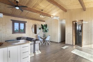A wooden interior with a dining area, a ceiling fan, and a large mirror. - Villa 'Fatema' with Private Pool, Wi-Fi, and Air Conditioning (Conil de la Frontera)