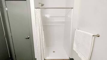 Shower, hair dryer, towels, toilet paper