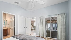 A bedroom with a bed, a ceiling fan, and a sliding glass door leading to a balcony. - Long term pricing - Charming 2 bed Villa awaits for you. (The Villages)