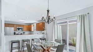A modern kitchen with wooden cabinets, stainless steel appliances, and a central island. - Long term pricing - Charming 2 bed Villa awaits for you. (The Villages)