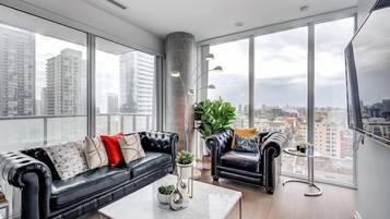 Business Apartment | Living area | 65-inch Smart TV with digital channels