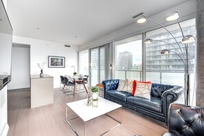 Business Apartment | Living area | 65-inch Smart TV with digital channels