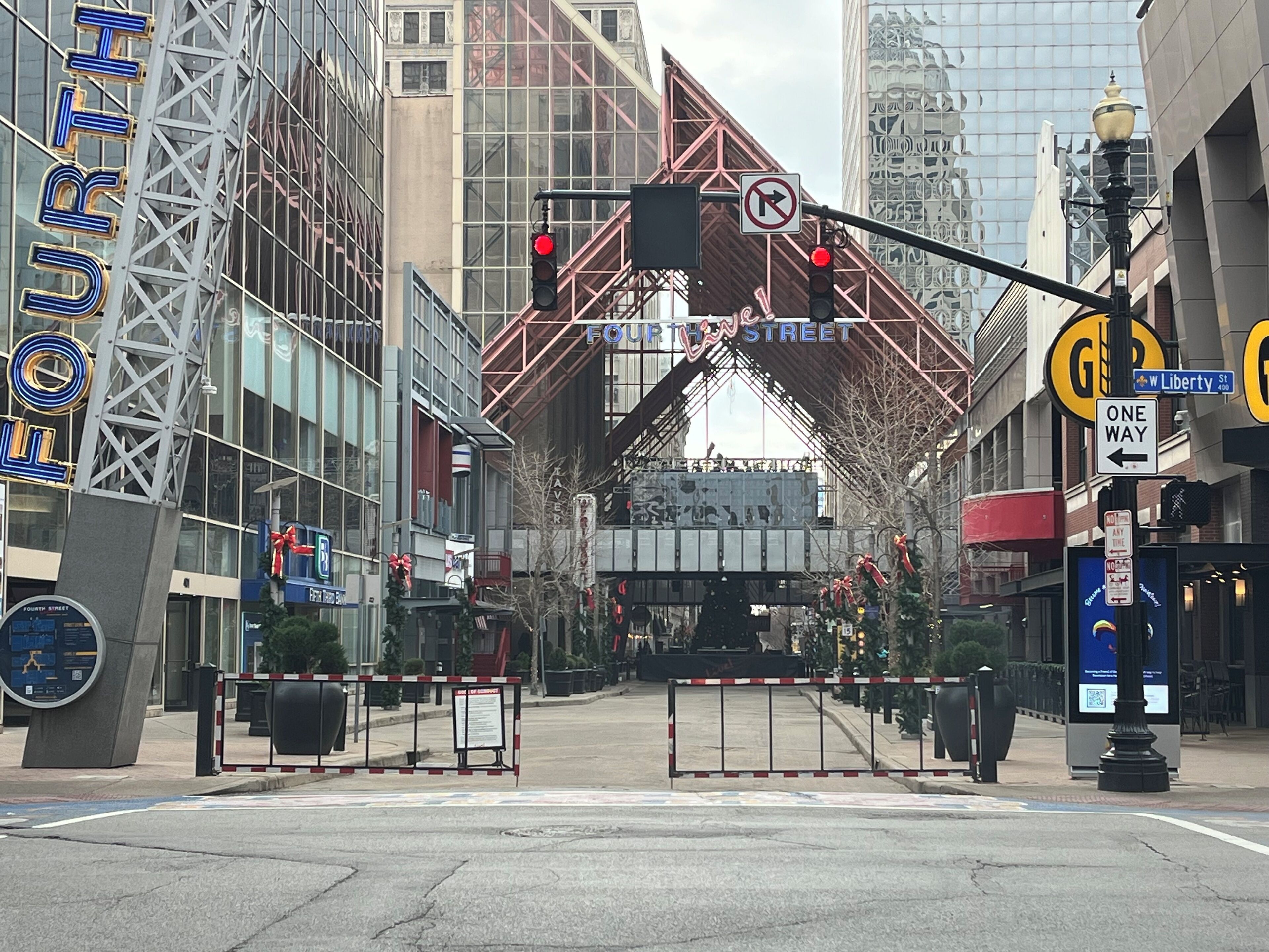 A street view with a traffic light, a no right turn sign, and a 'One Way' sign on Liberty Street.