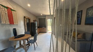 A modern interior with a dining area, kitchen, and living space. - Tulum Ayook apartment with Starlink (Tulum)