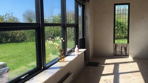 A room with large windows, a radiator, and a tiled floor. - Lovely holiday home on Lolland (Errindlev)