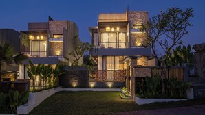 A modern two-story house with a stone facade, large windows, and a well-lit exterior. - Private Villa Ayra 9A 10min MelastiBeach (Ungasan)