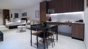 A modern kitchen with a dining area, wooden cabinets, and a built-in microwave.