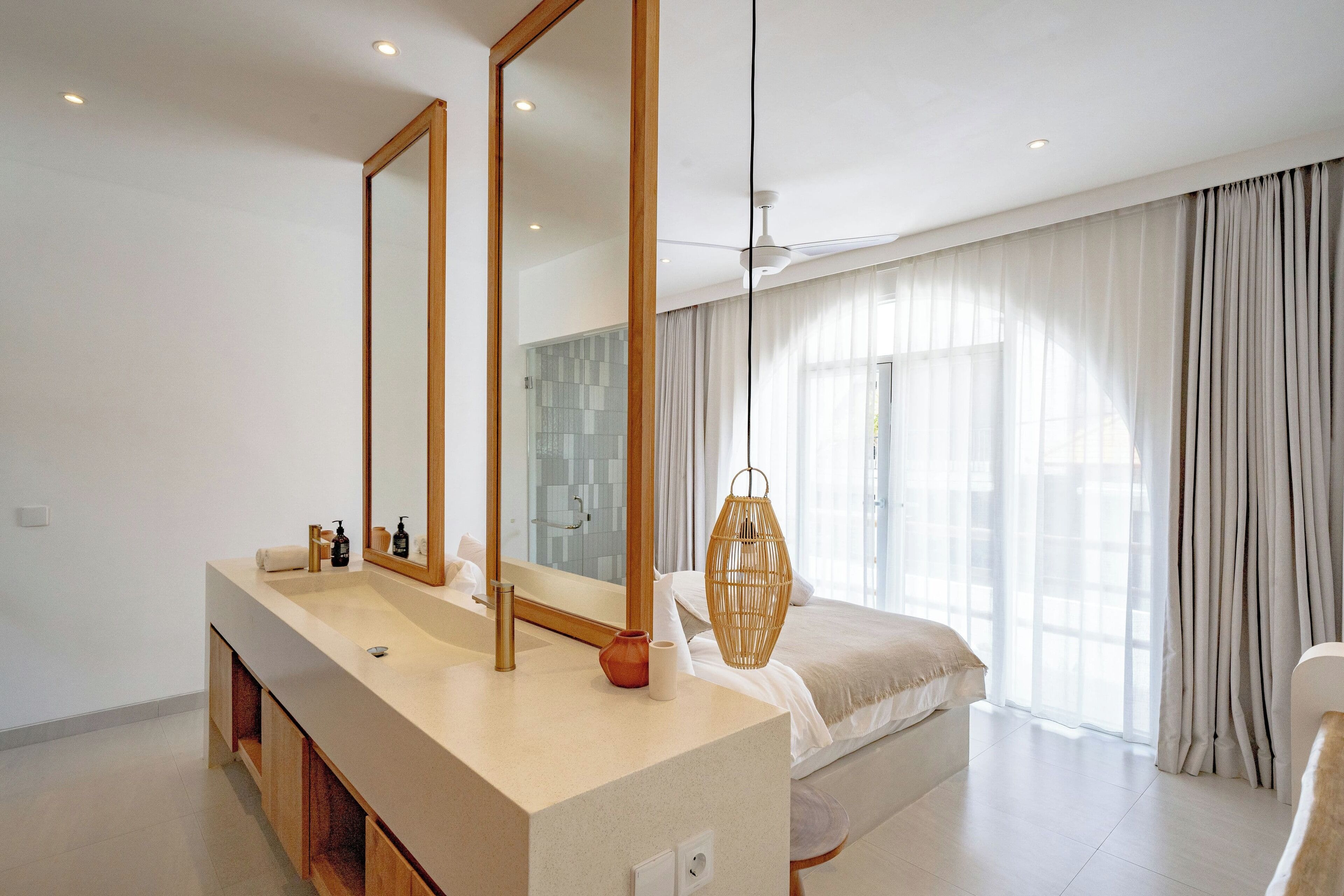 Een moderne badkamer met een grote spiegel, een wastafel en een douchehoek.