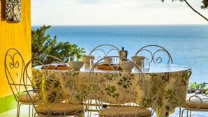 A table set for dining with a view of the sea. - Capo Boi by Interhome (Villasimius)