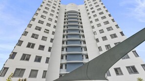 A high-rise building with a modern architectural design, featuring multiple balconies and a central atrium. - Centrepoint 31 Ocean Views, Walk To Bulcock Beach (Caloundra)