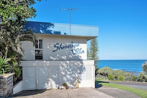 A two-story building with a sign reading 'Shoreline Villa' and a view of the ocean. - Shoreline U2 Walk To Kings Beach & Parklands (Kings Beach)