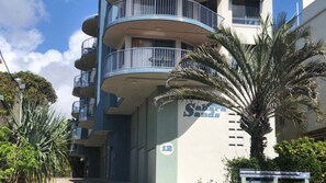 A multi-story building with balconies, a palm tree, and a sign indicating the name 'Saba Sands'. - Sahara Sands U4-Kings Beach Escape (Kings Beach)