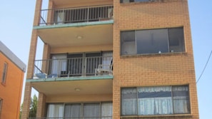 A multi-story building with balconies, large windows, and a brick facade. - Balamara U3 Water Views, Walk to Bulcock Beach (Caloundra)