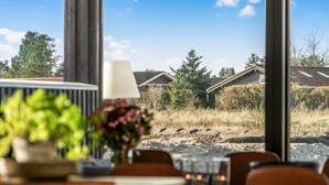 A dining area with a view of a building and trees.