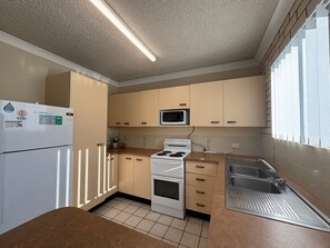 A kitchen with a refrigerator, microwave, stove, and sink. - Whiteopal Close To Kings Beach With Ocean Views (Kings Beach)