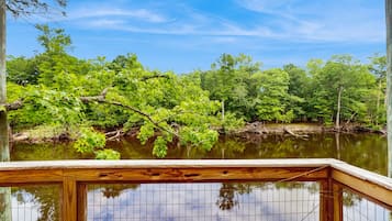 Enjoy serene lakeside views from the deck, overlooking the calm water and lush surroundings.