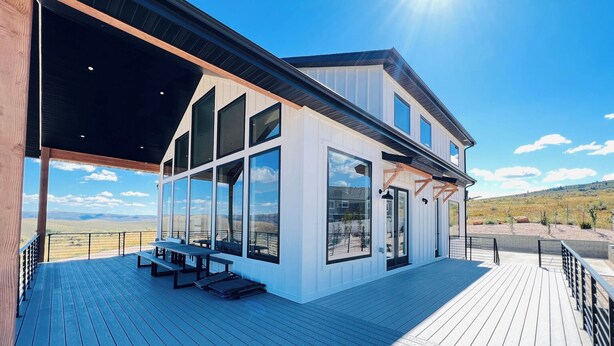 A modern building with large windows and a deck. - Bear Lake getaway for the whole family! Sleeps 32! Beach access included!! (Garden City)