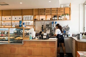 A bakery counter with baked goods and coffee-making equipment.