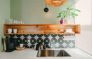 Swank 6: Stylish modern mini kitchenette featuring tiled splashback, coffee station, and pristine sink unit. - Swank Suites + Private Porch Patio (Ashland)