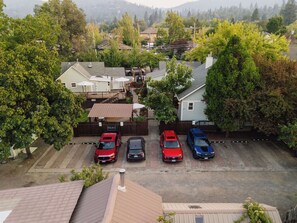 A residential area with a parking lot containing four cars.