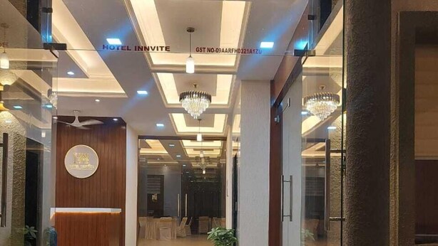 A hotel lobby with a reception desk, chandeliers, and a modern interior design. - Hotel Innvite (Agra)