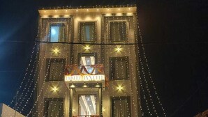 A hotel entrance with a sign reading "HOTEL INVITE" and a staircase leading to the entrance. There are two motorcycles parked in front. - Hotel Innvite (Agra)