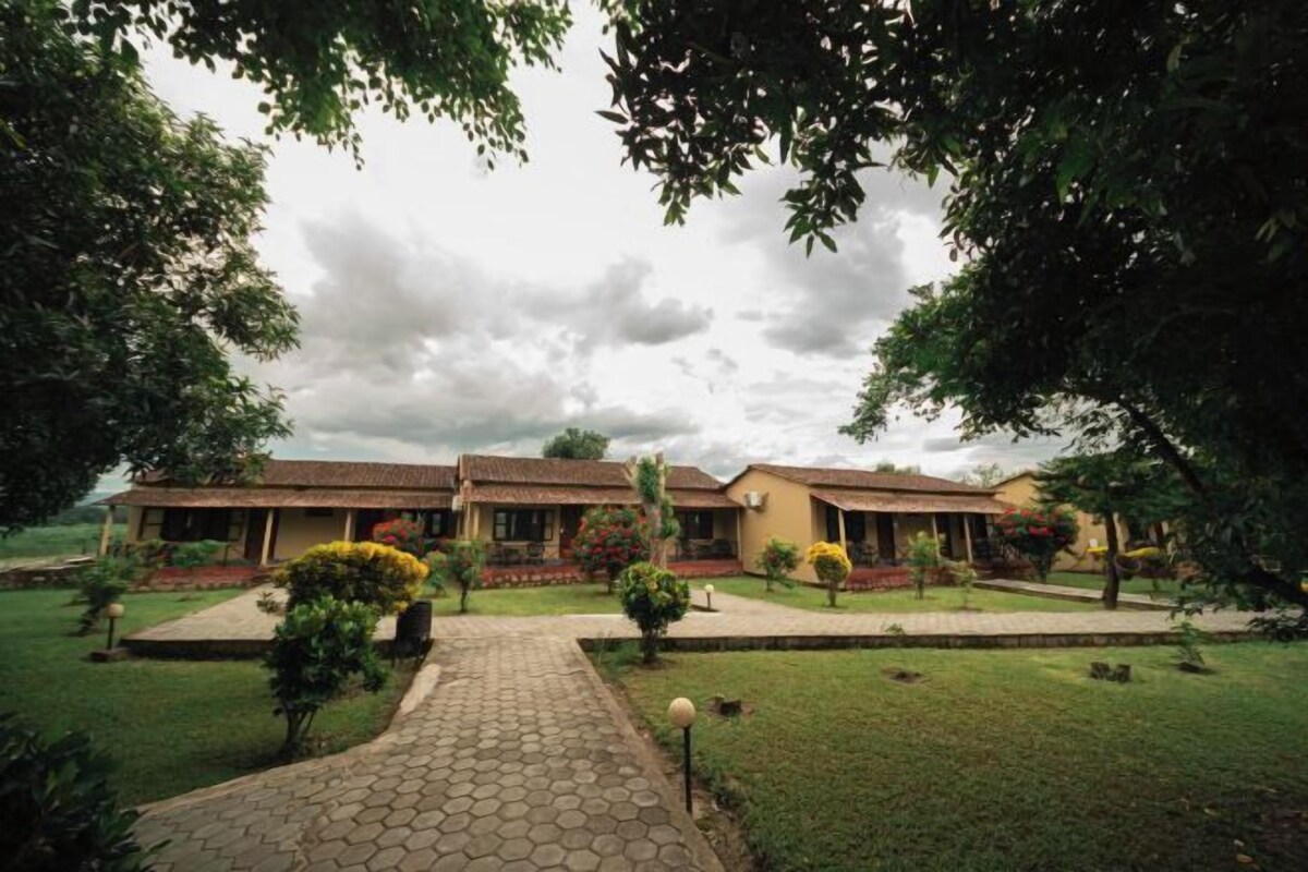 A residential area with a paved walkway leading to a row of houses with tiled roofs.