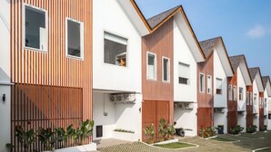 A row of modern, single-story houses with white exteriors and wooden accents. - A.K.A Cemagi Townhouse (Cemagi)