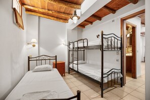 A room with a single bed, a wooden nightstand, and a bunk bed. - Countryside Apartment 1 With Shared Swimming Pool (Kissamos)