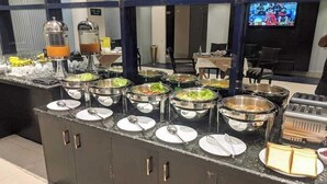 A buffet setup with various food stations, including salads, soups, and hot dishes, in a modern hotel setting. - Hotel Grand Royal Dhanmondi  (Dhaka)