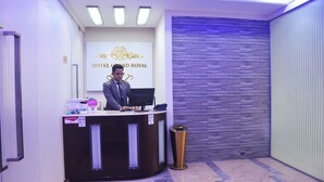 A reception desk at Hotel Grand Royal with a modern design, a digital screen, and a trash bin. - Hotel Grand Royal Dhanmondi  (Dhaka)