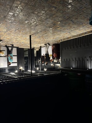 A room with a patterned ceiling, a bar area with stools, and a counter. - Hotel Jafson Accommodates (Srinagar)