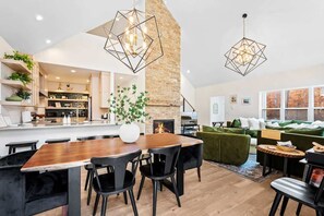 A modern living space with a kitchen, dining area, and seating area. - Pet-Friendly Modern Retreat · Woods · Ellison Bay (Ellison Bay)