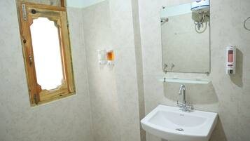 Family Quadruple Room, Courtyard View | Bathroom | Shower, slippers, towels, soap