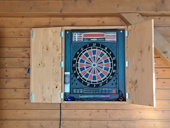 A dartboard mounted on a wooden wall with a digital score display. - "Large vacation home for groups & families at the Rhododendron Park Kromlau" (Kromlau)