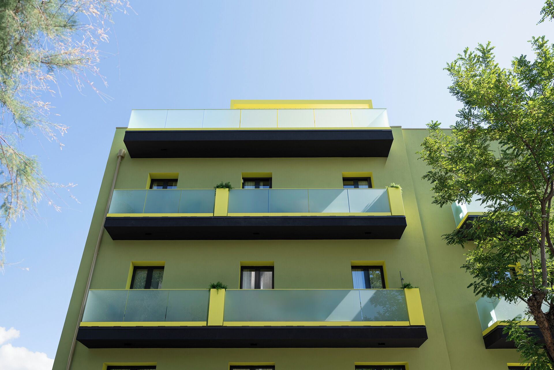 A multi-story building with balconies and windows.