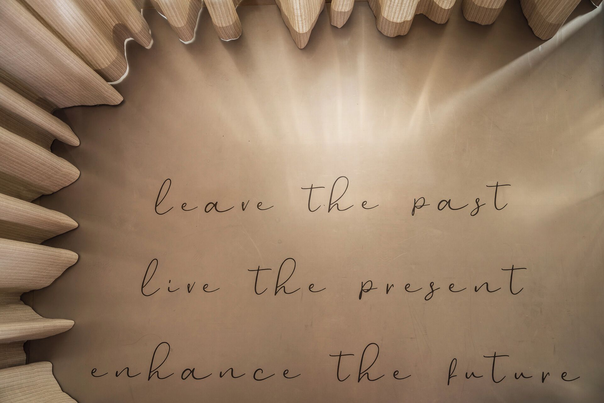 A handwritten message on a beige background with a light source creating a glow effect.