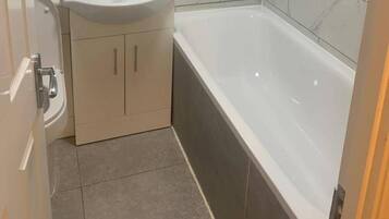 Separate bathtub and shower, deep-soaking bathtub, towels