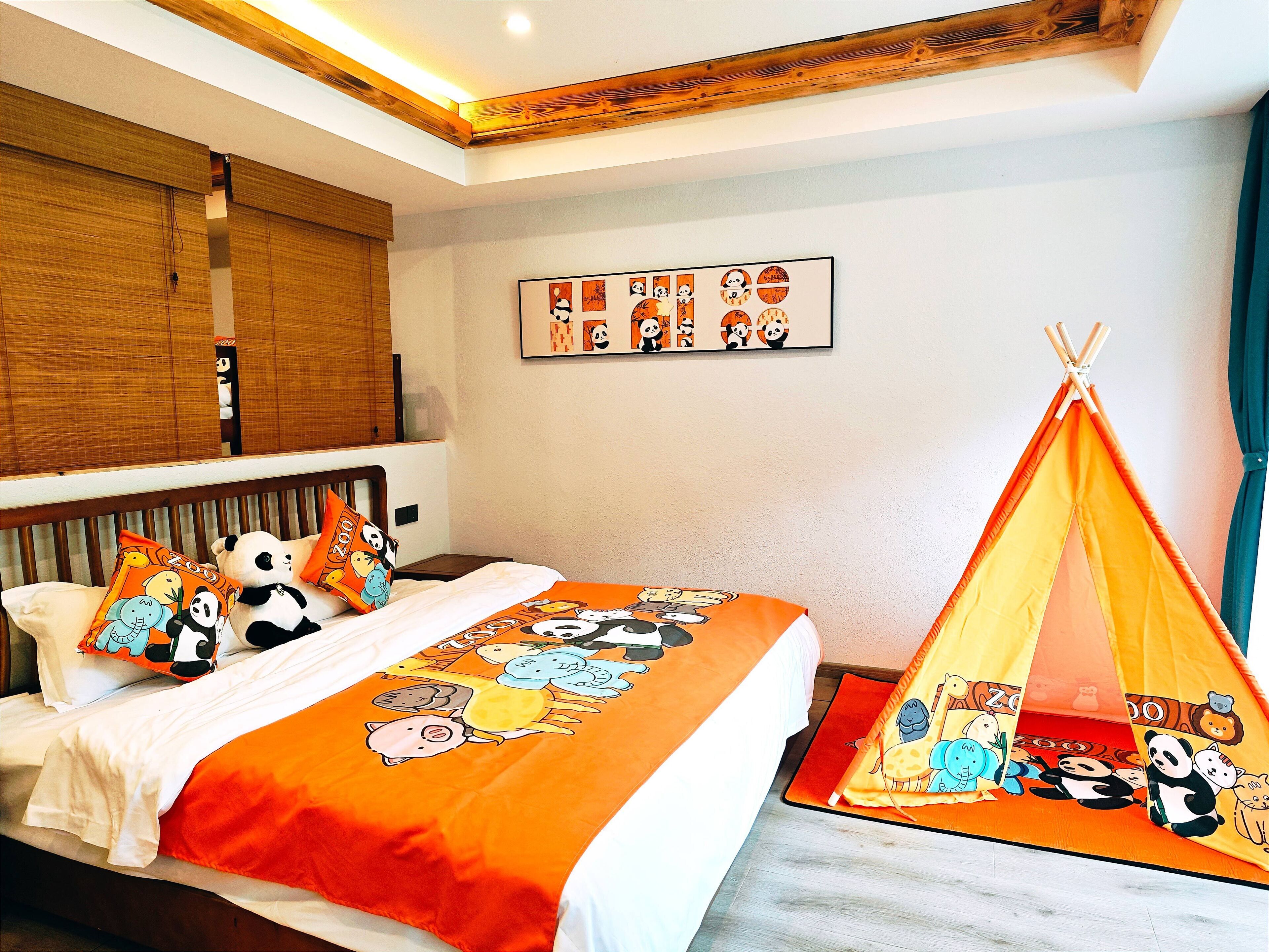 A bedroom with a bed, pillows, a wall-mounted artwork, and a teepee.