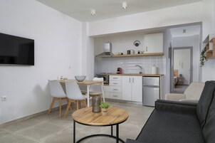 Fogão, cooktop, talheres/pratos/utensílios de cozinha, mesas de jantar